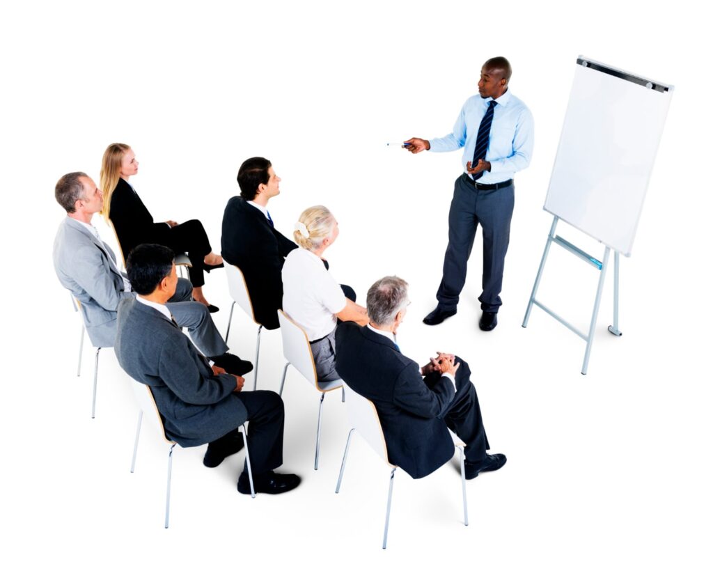 A man confidently explaining to a group of people on a whileboard