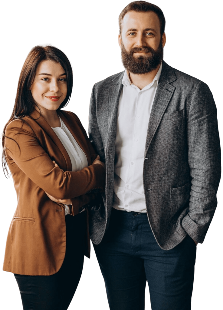 A man and a woman smiling while looking at the camera